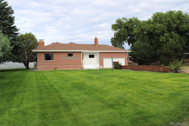 view of front of property featuring a front yard and a garage