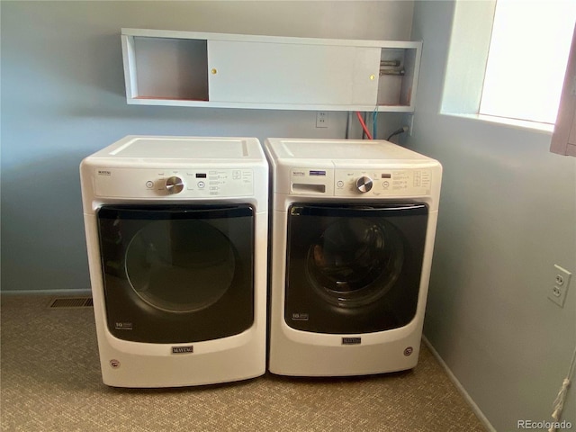 clothes washing area with washer and dryer and carpet