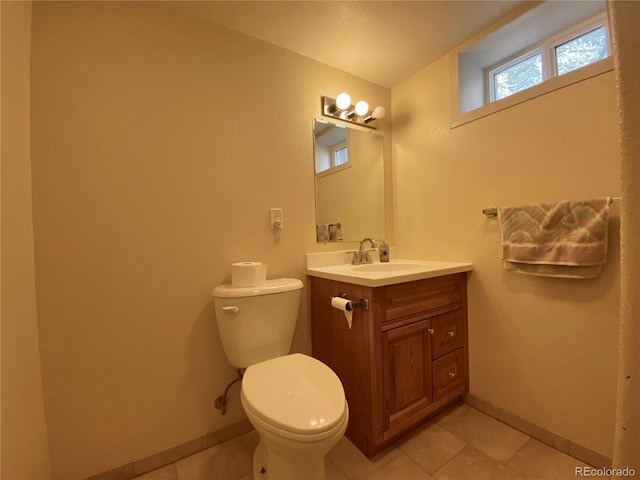 bathroom featuring tile patterned floors, vanity, and toilet