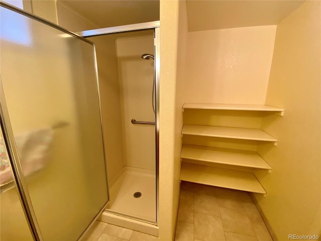 bathroom featuring a shower with door and tile patterned floors