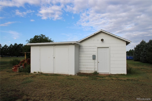 view of outbuilding with a yard