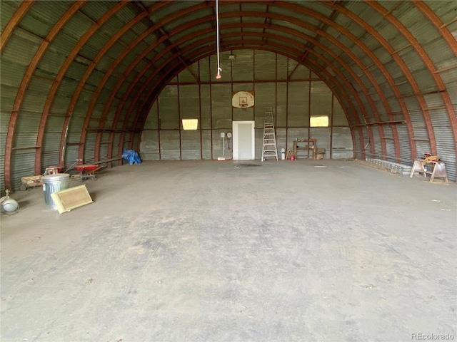 miscellaneous room with vaulted ceiling and concrete flooring