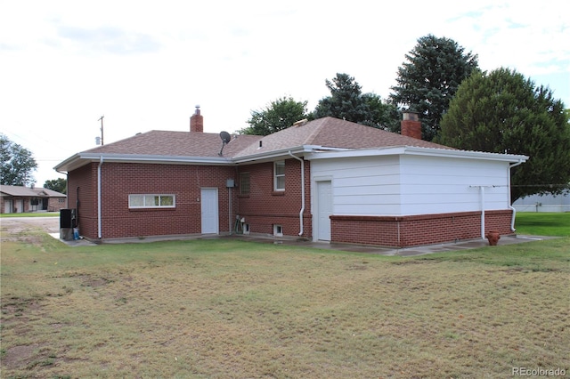 rear view of property with a yard