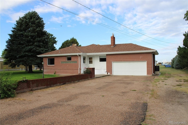 single story home featuring a front yard and a garage