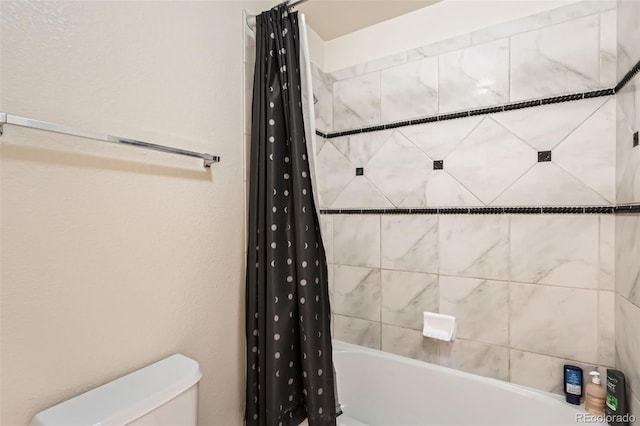 bathroom featuring shower / tub combo with curtain and toilet