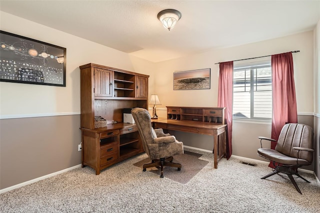 carpeted home office with baseboards