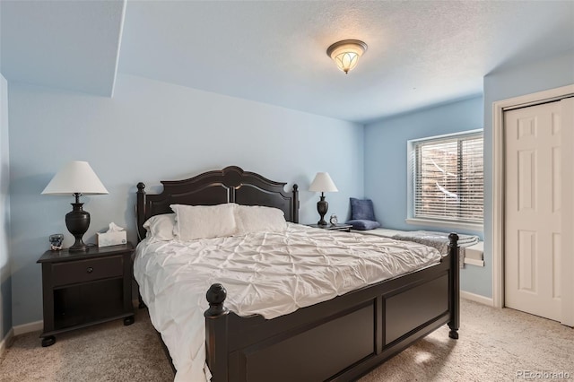 bedroom featuring baseboards and light colored carpet