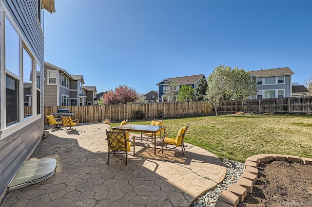 view of patio / terrace featuring a residential view, outdoor dining space, and a fenced backyard