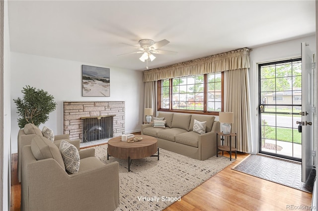 1840 E 84th Ave, Denver, CO 80229 - living area with wood finished floors, healthy amount of natural light, ceiling fan, and a fireplace