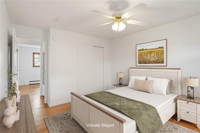 1840 E 84th Ave, Denver, CO 80229 - bedroom with a baseboard heating unit, light wood-style flooring, a closet, and a ceiling fan
