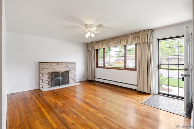 1840 E 84th Ave, Denver, CO 80229 - unfurnished living room with a baseboard radiator, ceiling fan, healthy amount of natural light, and a fireplace
