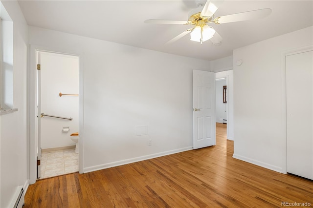 1840 E 84th Ave, Denver, CO 80229 - unfurnished bedroom featuring a baseboard heating unit, wood finished floors, baseboard heating, ensuite bath, and ceiling fan