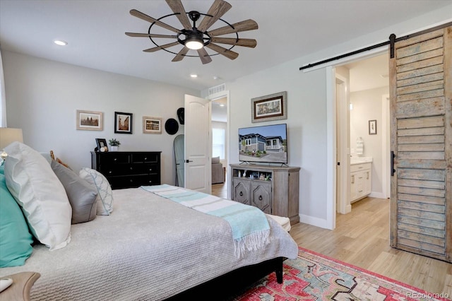 527 Felicity Loop, Castle Rock, CO 80109 - bedroom featuring a barn door, light wood-type flooring, recessed lighting, baseboards, and a ceiling fan