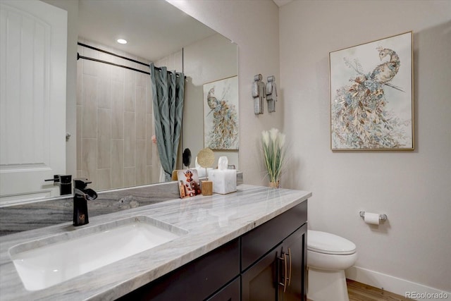 527 Felicity Loop, Castle Rock, CO 80109 - bathroom featuring vanity, toilet, baseboards, curtained shower, and wood finished floors