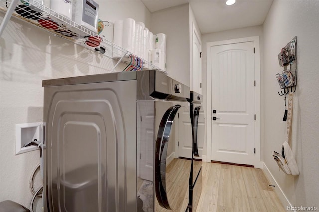 527 Felicity Loop, Castle Rock, CO 80109 - laundry room with light wood-style floors, washer and clothes dryer, recessed lighting, and baseboards