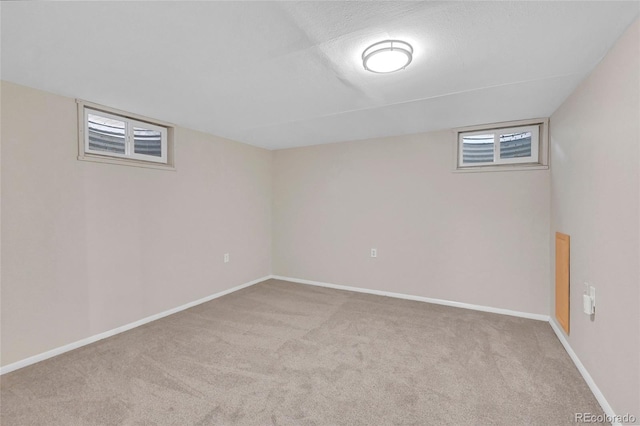 basement featuring light colored carpet