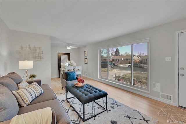 living room featuring ceiling fan and light hardwood / wood-style flooring