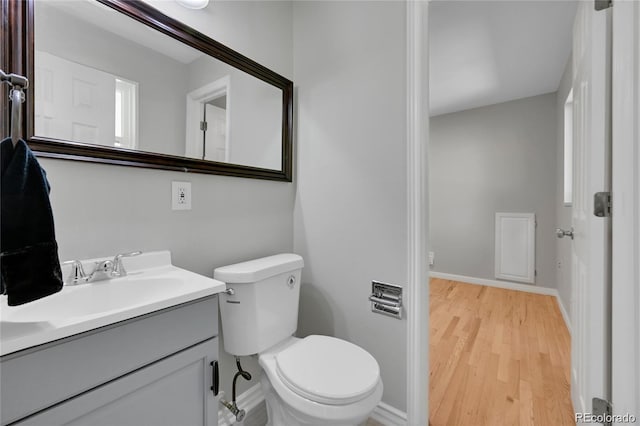 bathroom featuring toilet, wood-type flooring, and vanity