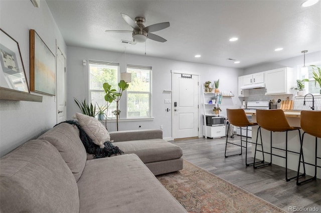 2829 W 53rd Ave Unit 104, Denver, CO 80221 - living area with wood finished floors, ceiling fan, and recessed lighting