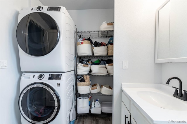 2829 W 53rd Ave Unit 104, Denver, CO 80221 - laundry room featuring estacked washer and dryer and wood finished floors