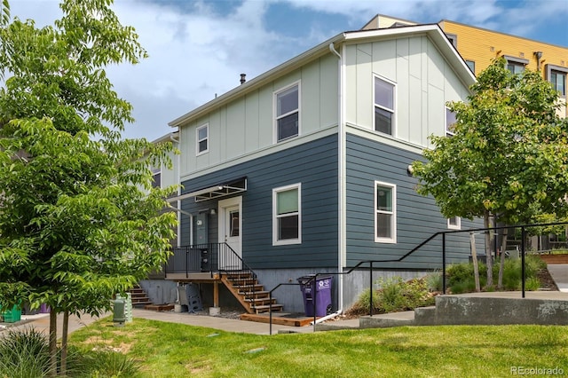 2829 W 53rd Ave Unit 104, Denver, CO 80221 - back of property featuring board and batten siding and a lawn