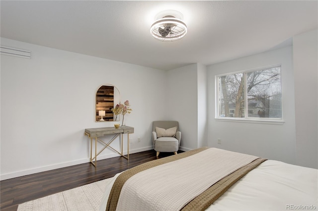 bedroom with wood finished floors and baseboards