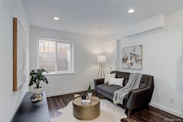 living area with recessed lighting, baseboards, and wood finished floors