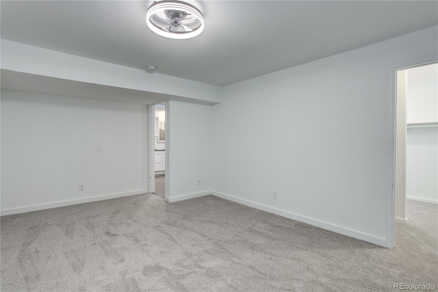 interior space featuring baseboards, carpet floors, and a textured ceiling