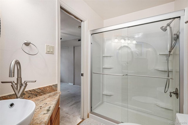 full bath with vanity and a shower stall