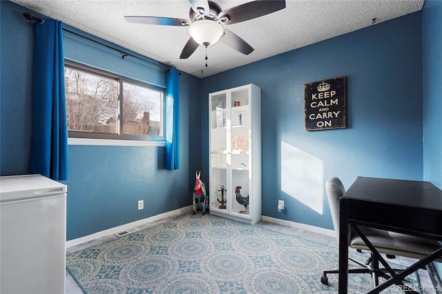 office area featuring ceiling fan and a textured ceiling