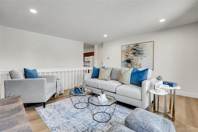 living room with hardwood / wood-style floors and a textured ceiling