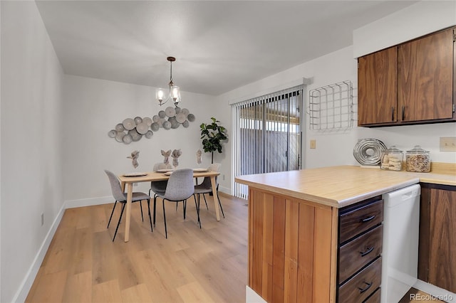 kitchen featuring hanging light fixtures, light hardwood / wood-style flooring, dishwasher, and a chandelier