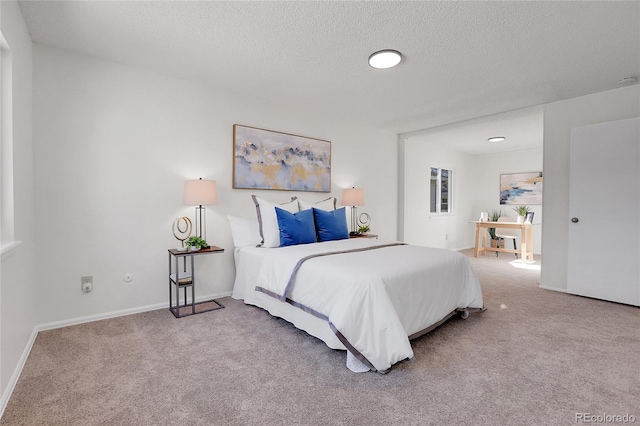 bedroom featuring carpet and a textured ceiling