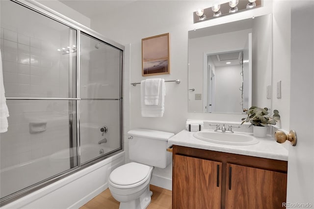 full bathroom with vanity, shower / bath combination with glass door, and toilet