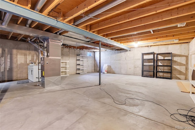 basement with separate washer and dryer and heating unit