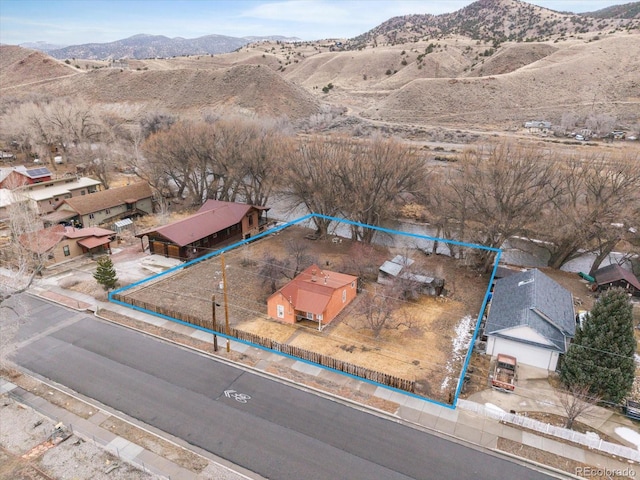 birds eye view of property with a mountain view