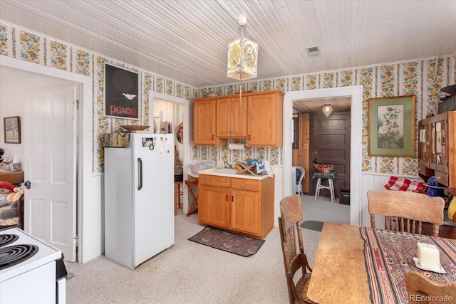 kitchen featuring white appliances and light carpet