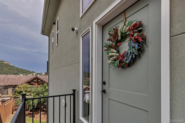 265 Upper Glenway, Palmer Lake, CO 80133 - property entrance featuring stucco siding, a balcony, and a security system