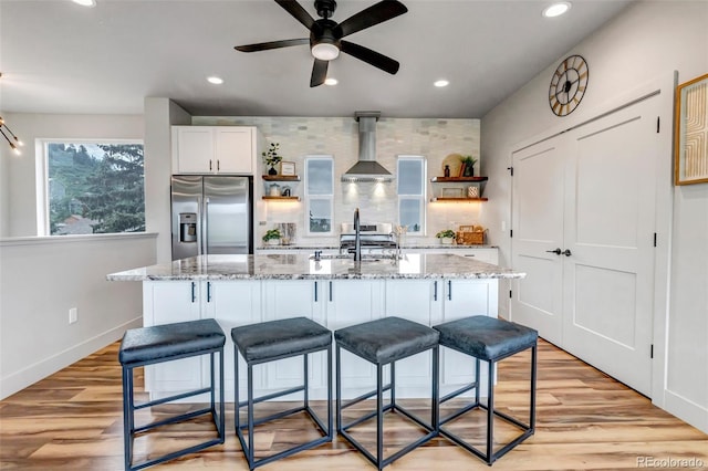265 Upper Glenway, Palmer Lake, CO 80133 - kitchen with stainless steel appliances, open shelves, wall chimney exhaust hood, a ceiling fan, and recessed lighting