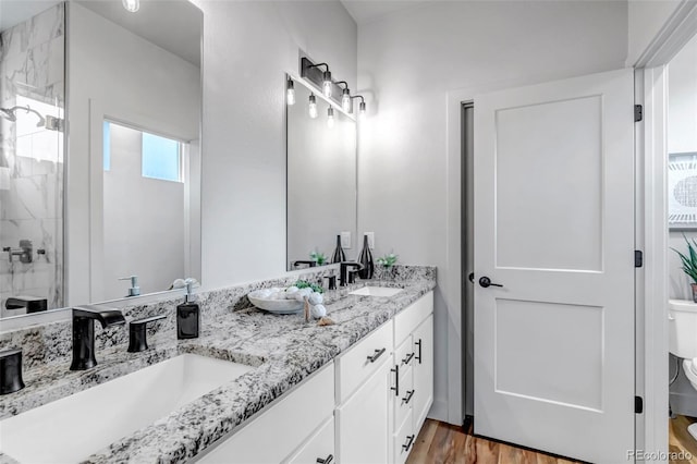 265 Upper Glenway, Palmer Lake, CO 80133 - full bathroom featuring double vanity, tiled shower, and wood finished floors