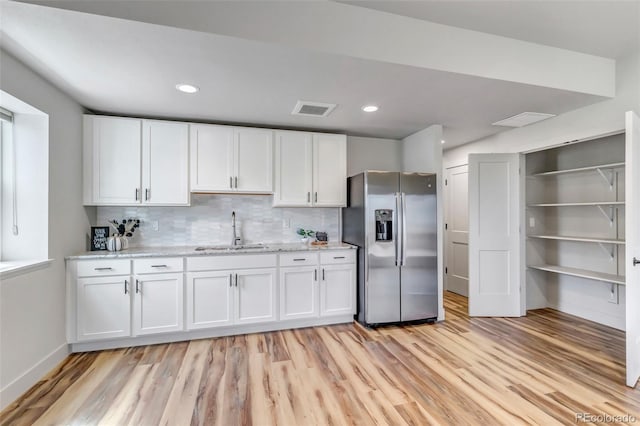 265 Upper Glenway, Palmer Lake, CO 80133 - kitchen featuring stainless steel fridge, light wood-style floors, white cabinetry, backsplash, and recessed lighting