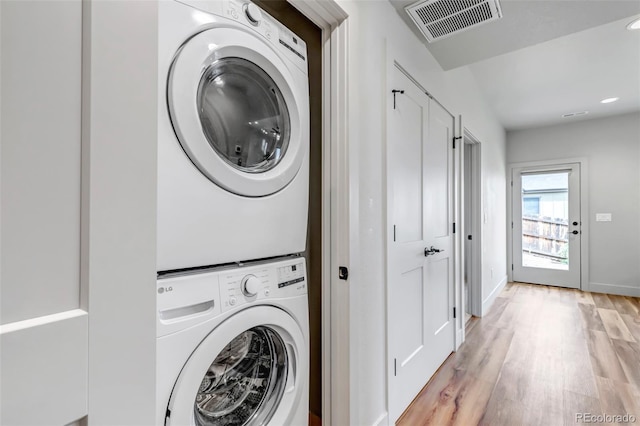 265 Upper Glenway, Palmer Lake, CO 80133 - laundry room featuring stacked washing machine and dryer, light wood-type flooring, and recessed lighting