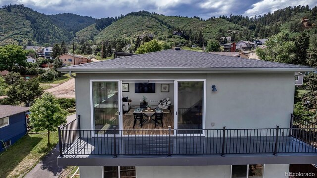 265 Upper Glenway, Palmer Lake, CO 80133 - back of property featuring stucco siding, a mountain view, and a shingled roof