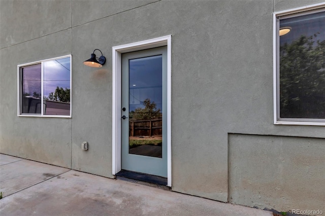 265 Upper Glenway, Palmer Lake, CO 80133 - doorway to property with stucco siding and a patio area