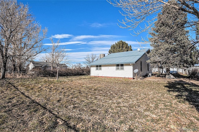 view of side of property with a yard