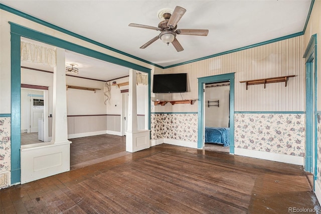 unfurnished room with decorative columns, ceiling fan, dark hardwood / wood-style floors, and ornamental molding