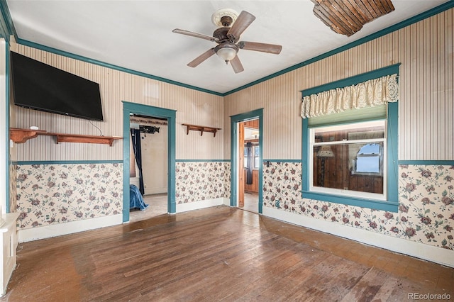 spare room featuring ceiling fan, wood-type flooring, and ornamental molding