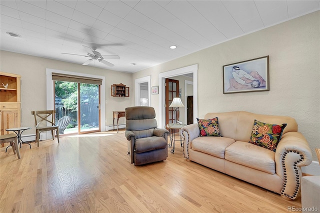 living area featuring a ceiling fan, light wood-type flooring, and baseboard heating