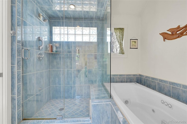 full bathroom featuring a shower stall and a jetted tub