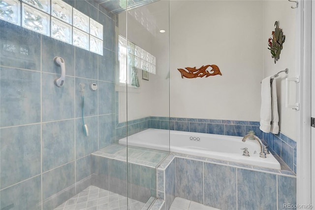 bathroom featuring a tile shower and a garden tub